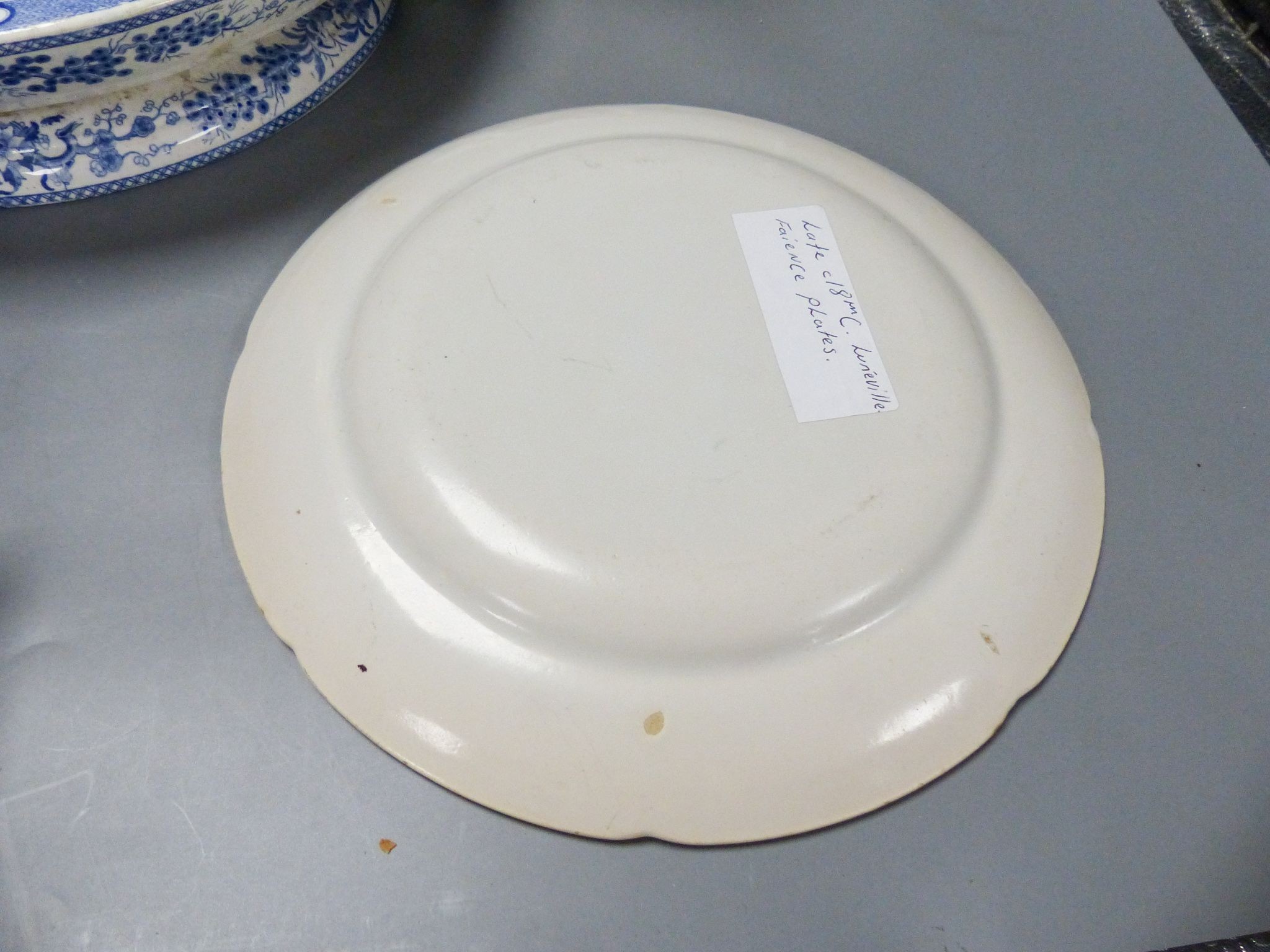 An ironstone cheese stand and a pair of French faience plates 30cm